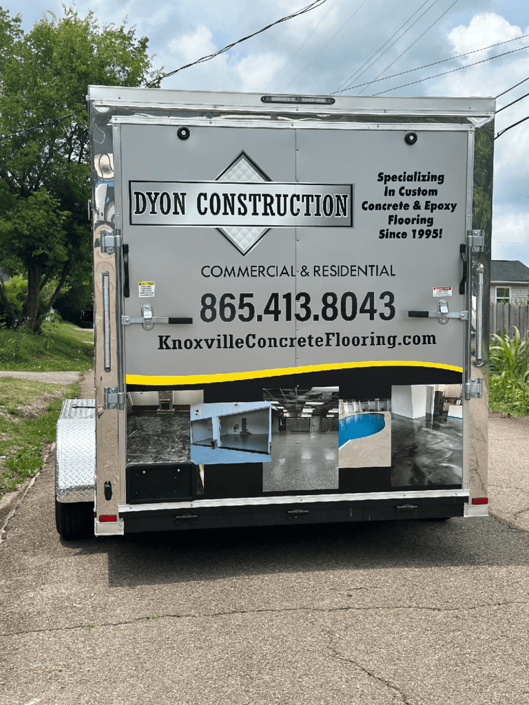 Photo showing the back of our trailer, where we have our number, website and our name Dyon Construction