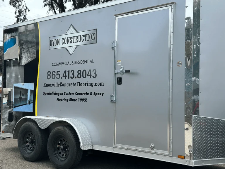 Photo showing the side of our trailer, where we have our number, website and our name Dyon Construction