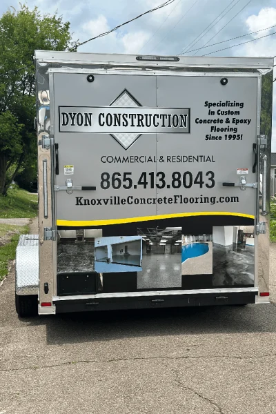 Photo showing the back of our trailer, where we have our number, website and our name Dyon Construction